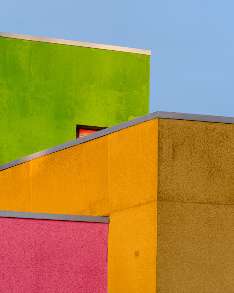 Building front with green and yellow panels